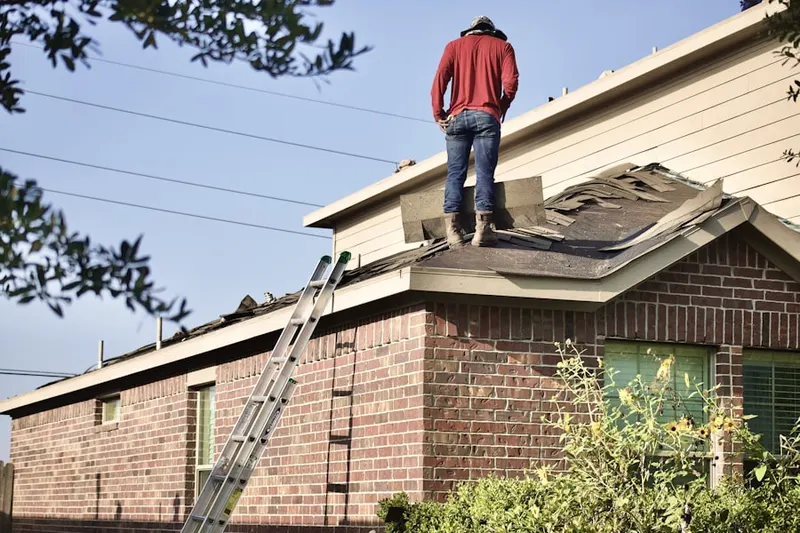 Professional roofer working on a residential roof in Buckingham Hills